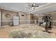 Finished basement with home gym, white mini fridge, neutral paint, and tile flooring at 170 Homestead Rd, Angier, NC 27501