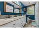 Nautical-themed bathroom featuring a double vanity with stone countertops and ample storage at 170 Homestead Rd, Angier, NC 27501