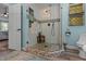 Shower features a glass enclosure, river rock floor, and tiled walls, adding natural elements at 170 Homestead Rd, Angier, NC 27501
