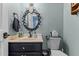 Stylish bathroom with decorative mirror and a vanity with black cabinet and tan countertop at 170 Homestead Rd, Angier, NC 27501