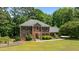 Beautiful brick home with a well-kept lawn and mature landscaping at 170 Homestead Rd, Angier, NC 27501