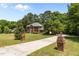 Charming two-story brick home with a well-manicured lawn and a long driveway at 170 Homestead Rd, Angier, NC 27501