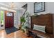 Inviting foyer with hardwood floors, decorative chandelier, and a cozy bench with a 'welcome' pillow at 170 Homestead Rd, Angier, NC 27501