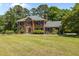 Traditional brick home with a well-manicured lawn and mature trees, featuring classic black shutters at 170 Homestead Rd, Angier, NC 27501