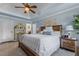 Bright main bedroom featuring a queen sized bed, decorative fireplace, and light blue walls at 170 Homestead Rd, Angier, NC 27501