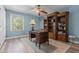 Office featuring hardwood floors, a built-in bookcase, and a desk for productivity at 170 Homestead Rd, Angier, NC 27501