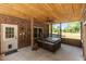 Cozy covered patio featuring a hot tub, brick walls, and a ceiling fan at 170 Homestead Rd, Angier, NC 27501