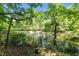 A still pond reflects the surrounding trees, creating a tranquil and picturesque scene at 170 Homestead Rd, Angier, NC 27501