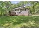 Well-maintained backyard with a screened-in porch, wood deck, and mature trees at 1705 Bridgeport Dr, Raleigh, NC 27615
