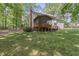Large backyard with a screened-in porch and mature trees at 1705 Bridgeport Dr, Raleigh, NC 27615
