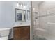 Bathroom featuring a glass shower with tile surround, a modern vanity, and updated fixtures at 1705 Bridgeport Dr, Raleigh, NC 27615