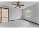 Bedroom with neutral walls, gray carpet, ceiling fan, natural light, and access to additional attic space at 1705 Bridgeport Dr, Raleigh, NC 27615