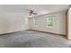 Spacious bedroom featuring a ceiling fan, and two windows offering views of the surrounding greenery at 1705 Bridgeport Dr, Raleigh, NC 27615