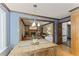 Open-concept dining area with view of living room fireplace, blue walls, and hardwood flooring at 1705 Bridgeport Dr, Raleigh, NC 27615
