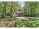 Exterior of home with well manicured lawn and mature shade trees at 1705 Bridgeport Dr, Raleigh, NC 27615