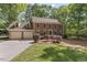 Two-story brick home featuring a two-car garage, dormer windows, and landscaped front yard at 1705 Bridgeport Dr, Raleigh, NC 27615