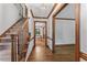Foyer with hardwood floors, staircase, and view into dining area with natural light at 1705 Bridgeport Dr, Raleigh, NC 27615
