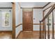 Open foyer featuring hardwood floors, dark wood trim, and a solid wood door at 1705 Bridgeport Dr, Raleigh, NC 27615