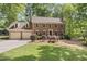 Brick home with a two-car garage and landscaped front yard at 1705 Bridgeport Dr, Raleigh, NC 27615