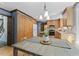 Eat-in kitchen featuring wooden cabinetry, stainless steel appliances, and light countertops at 1705 Bridgeport Dr, Raleigh, NC 27615
