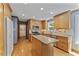 Kitchen featuring wooden cabinets, stainless steel appliances, and an island with a stone countertop at 1705 Bridgeport Dr, Raleigh, NC 27615