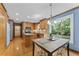 Bright eat-in kitchen featuring wood cabinets, stainless appliances, and breakfast nook with nature views at 1705 Bridgeport Dr, Raleigh, NC 27615
