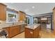This is a cozy kitchen with an island and hardwood floors, with updated stainless steel appliances at 1705 Bridgeport Dr, Raleigh, NC 27615
