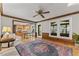Inviting living room featuring hardwood floors, wood trim, a ceiling fan, and an eat-in kitchen at 1705 Bridgeport Dr, Raleigh, NC 27615