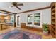 Charming living room with wood trim details, hardwood floors, and views into the adjoining kitchen and sunroom at 1705 Bridgeport Dr, Raleigh, NC 27615