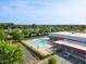Aerial view of the community, highlighting the swimming pool, tennis courts, and surrounding green spaces at 1826 Heisser Ln, Fuquay Varina, NC 27526