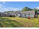 Large backyard with a spacious lawn, patio, and play set - perfect for outdoor living and entertaining at 1826 Heisser Ln, Fuquay Varina, NC 27526