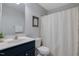 Neutral bathroom featuring a shower with curtain and a large vanity at 1826 Heisser Ln, Fuquay Varina, NC 27526