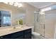 Beautiful bathroom with a glass shower, a sleek sink, and a window to let in natural light at 1826 Heisser Ln, Fuquay Varina, NC 27526
