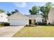 Well-maintained home featuring a two-car garage, manicured lawn, and charming front garden at 1826 Heisser Ln, Fuquay Varina, NC 27526