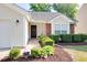 Close-up of home's entrance, showcasing a decorative wreath and manicured bushes at 1826 Heisser Ln, Fuquay Varina, NC 27526