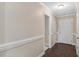 Hallway with dark floors and white trim leads to the front door at 1826 Heisser Ln, Fuquay Varina, NC 27526
