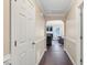 Inviting hallway with hardwood floors leads to a comfortable living area with natural light at 1826 Heisser Ln, Fuquay Varina, NC 27526