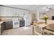 Bright kitchen with white cabinets and modern appliances adjacent to dining area at 1826 Heisser Ln, Fuquay Varina, NC 27526