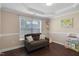 Cozy living room with a dark brown couch, large window, decorative molding, and a map at 1826 Heisser Ln, Fuquay Varina, NC 27526