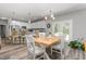 Open dining area featuring an island, modern light fixture, and white shaker cabinets at 1840 Willie Pace Rd, Burlington, NC 27217