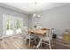 Dining room with french doors, hardwood floors, modern chandelier and white chairs at 1840 Willie Pace Rd, Burlington, NC 27217