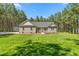 Charming single-story home featuring gray siding, symmetrical facade, and well-manicured lawn surrounded by mature trees at 1840 Willie Pace Rd, Burlington, NC 27217