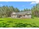 Charming single-story home with gray siding and symmetrical facade, set against a backdrop of lush, mature trees at 1840 Willie Pace Rd, Burlington, NC 27217