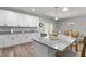 Open kitchen with an island, granite countertops, stainless steel appliances, and white cabinetry at 1840 Willie Pace Rd, Burlington, NC 27217