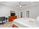 View of primary bedroom with wood floors, large bed, dresser, and desk with chair at 1840 Willie Pace Rd, Burlington, NC 27217