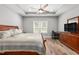 Primary bedroom with wood floors, trey ceiling, ceiling fan, and view of a window at 1840 Willie Pace Rd, Burlington, NC 27217
