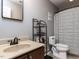 Cozy bathroom featuring a vanity with a sink, a toilet, and a shower with a striped curtain at 1909 Whirlaway Ct., Cary, NC 27519