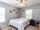 This bedroom boasts neutral walls, a ceiling fan, and beach-themed decor for a relaxing vibe at 1909 Whirlaway Ct., Cary, NC 27519