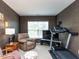 Cozy bonus room with textured wallpaper, a window with blinds, a recliner, and a treadmill at 1909 Whirlaway Ct., Cary, NC 27519