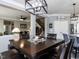 Bright dining area featuring a decorative light fixture, view to the living room, and wooden staircase at 1909 Whirlaway Ct., Cary, NC 27519